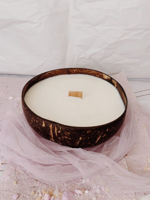 Candle in a coconut shell on top of tulle