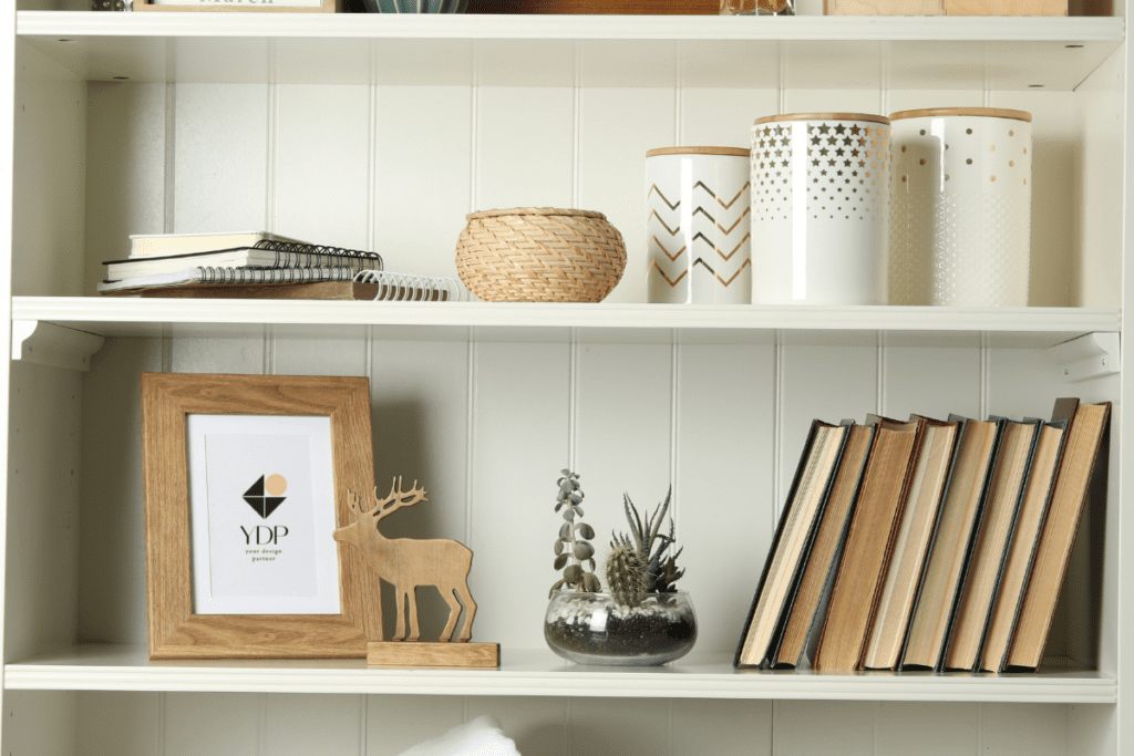 styled bookshelves with ceramic containers and books.