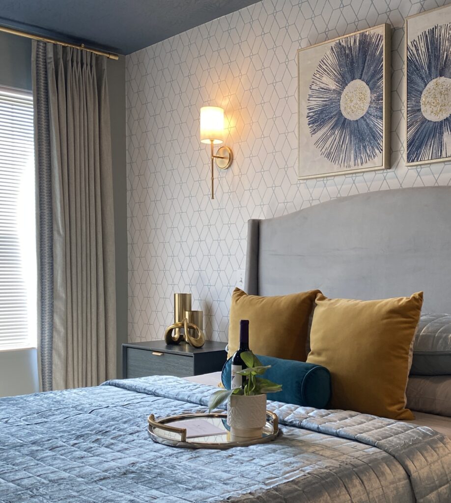 bedroom with blue and yellow accent colors and geometric wallpaper